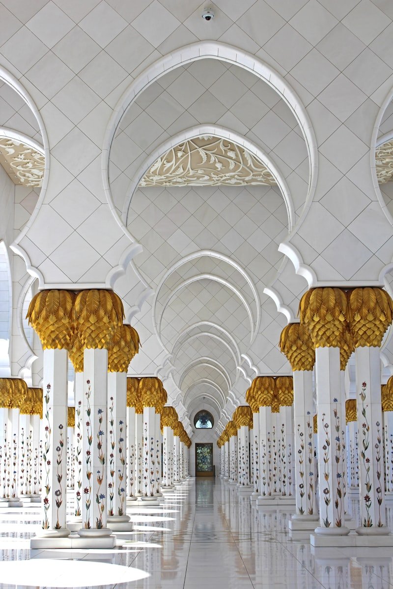 A white and gold mosque colonnade